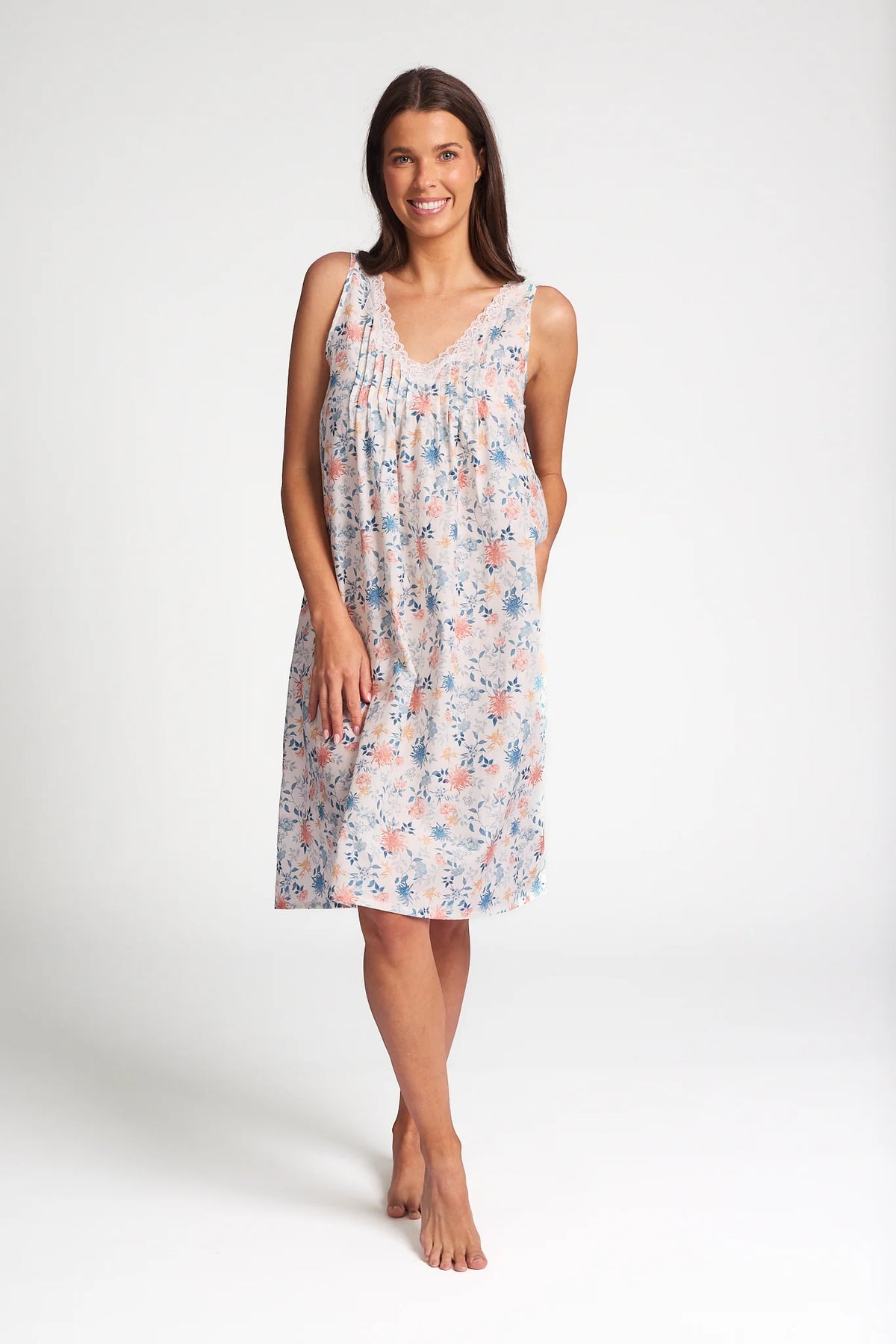 A soft sleeveless cotton silk nightie in light pastel with delicate pink and blue floral patterns on a pale background