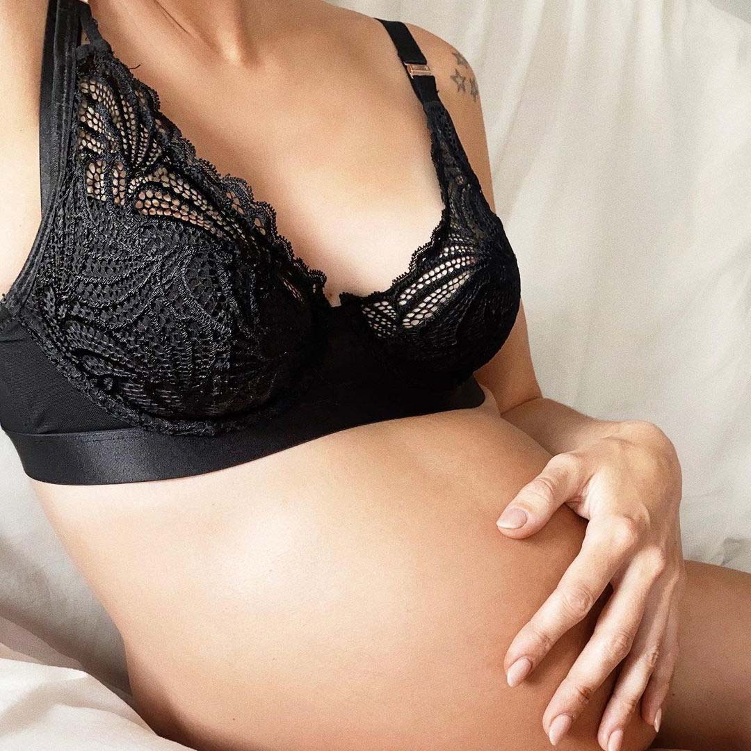 Pregnant woman in black maternity bra