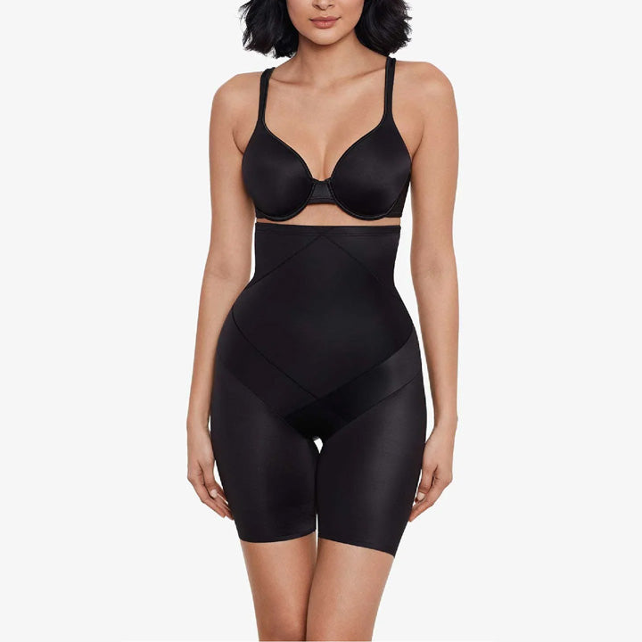 Black shapewear outfit worn by a model on a white background