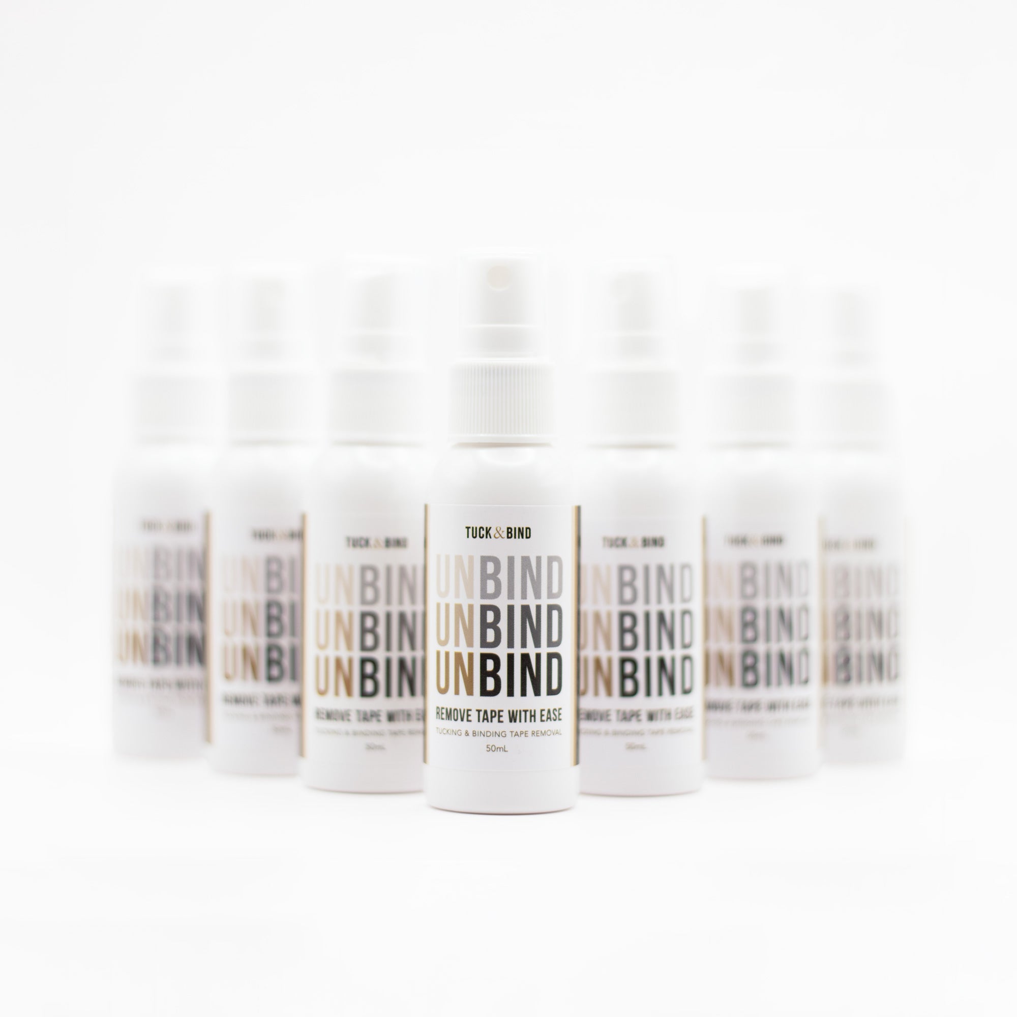 UNBIND Adhesive Removal Spray white bottle removes tape residue easily