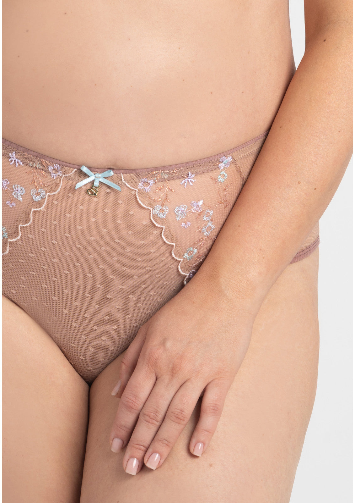 Beige lace thong brief with delicate floral embroidery and light blue bow accent from Margaret Figs collection