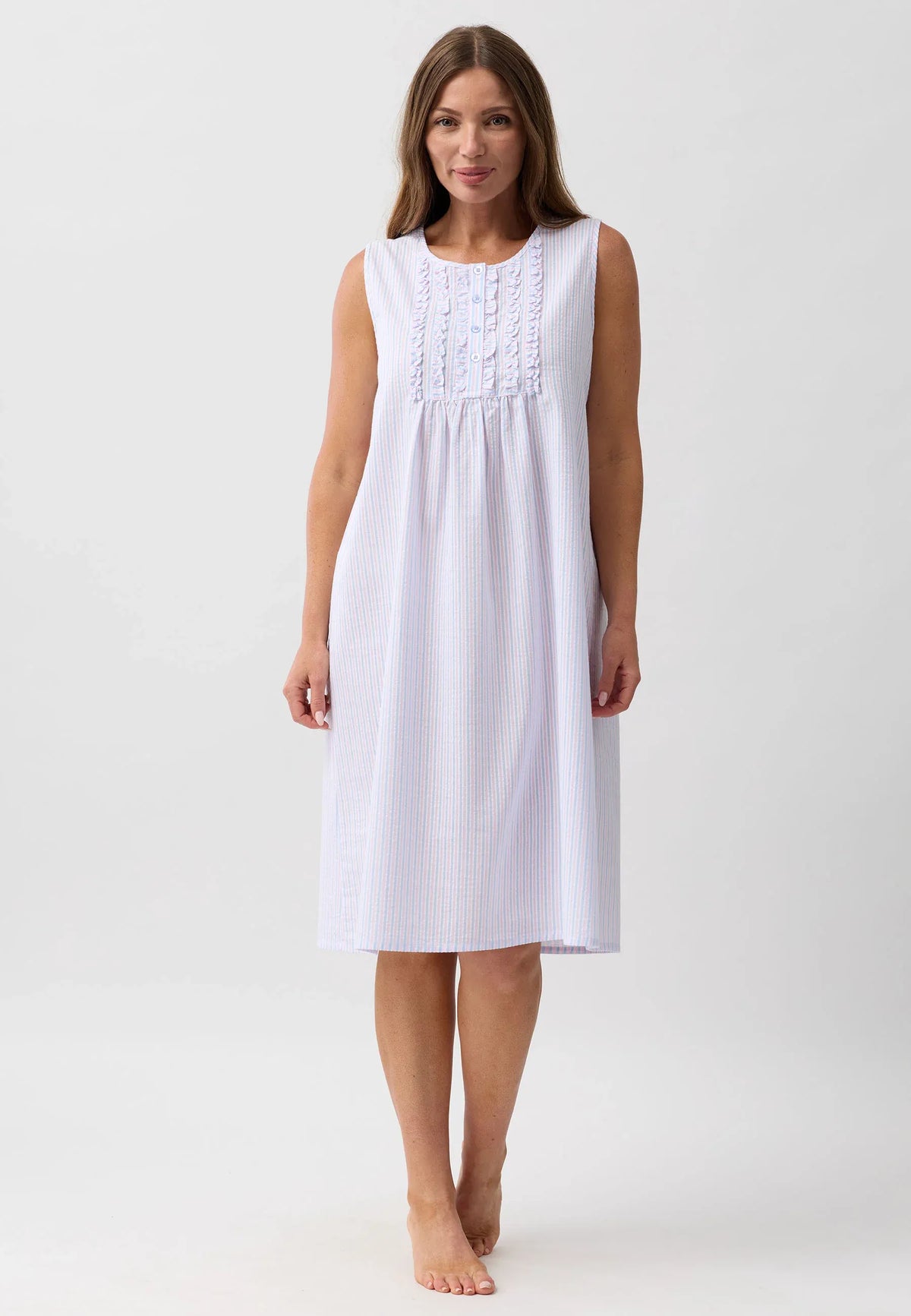 White sleeveless stripe nightie with subtle vertical stripes and delicate ruffled embroidery at the neckline
