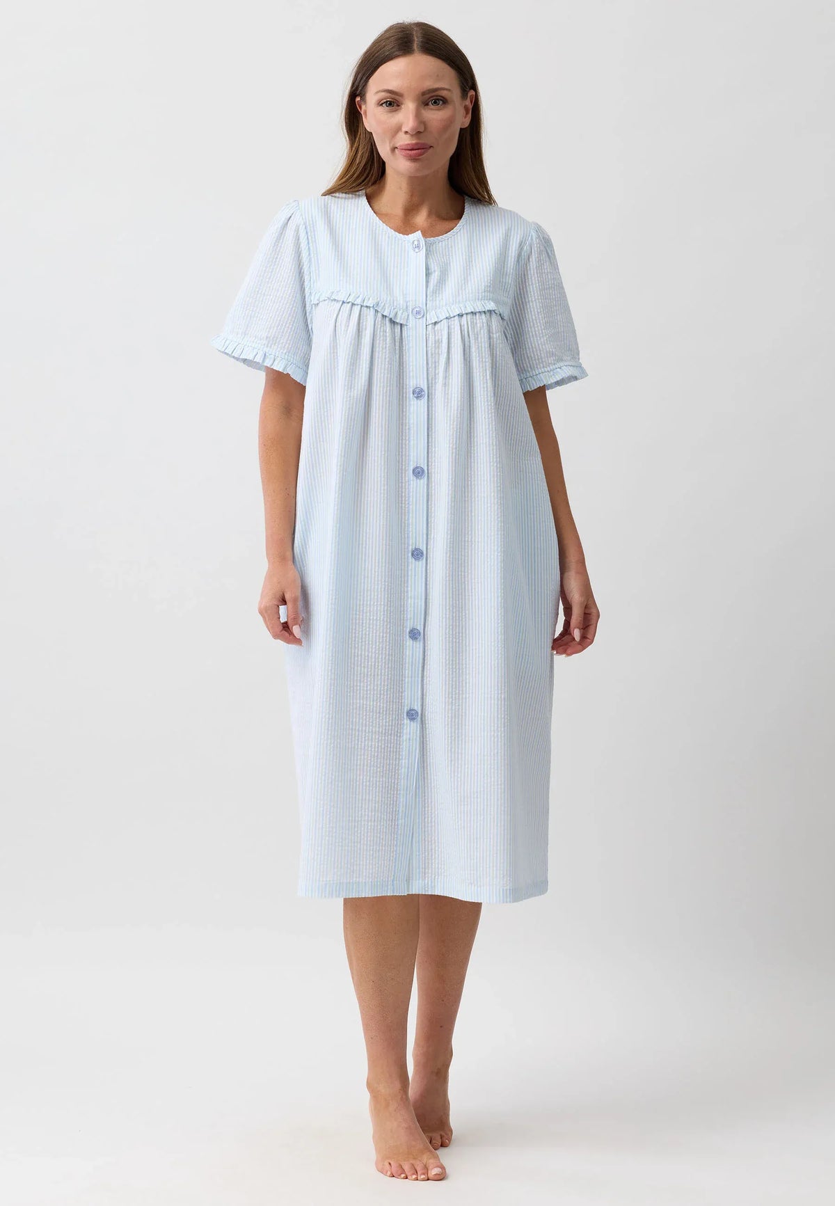 A light blue and white vertically striped cotton stripe brunch coat with short sleeves and front buttons