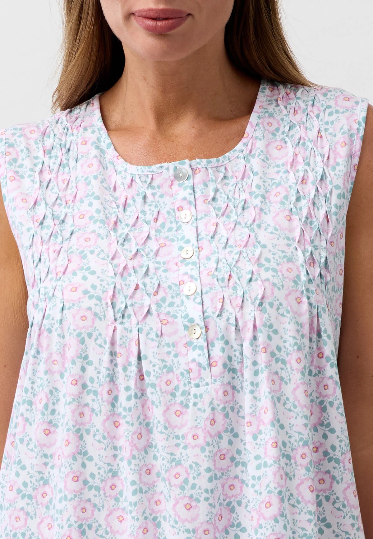 Camellia sleeveless nightie in soft mint green with pink floral pattern and delicate smocking at the neckline