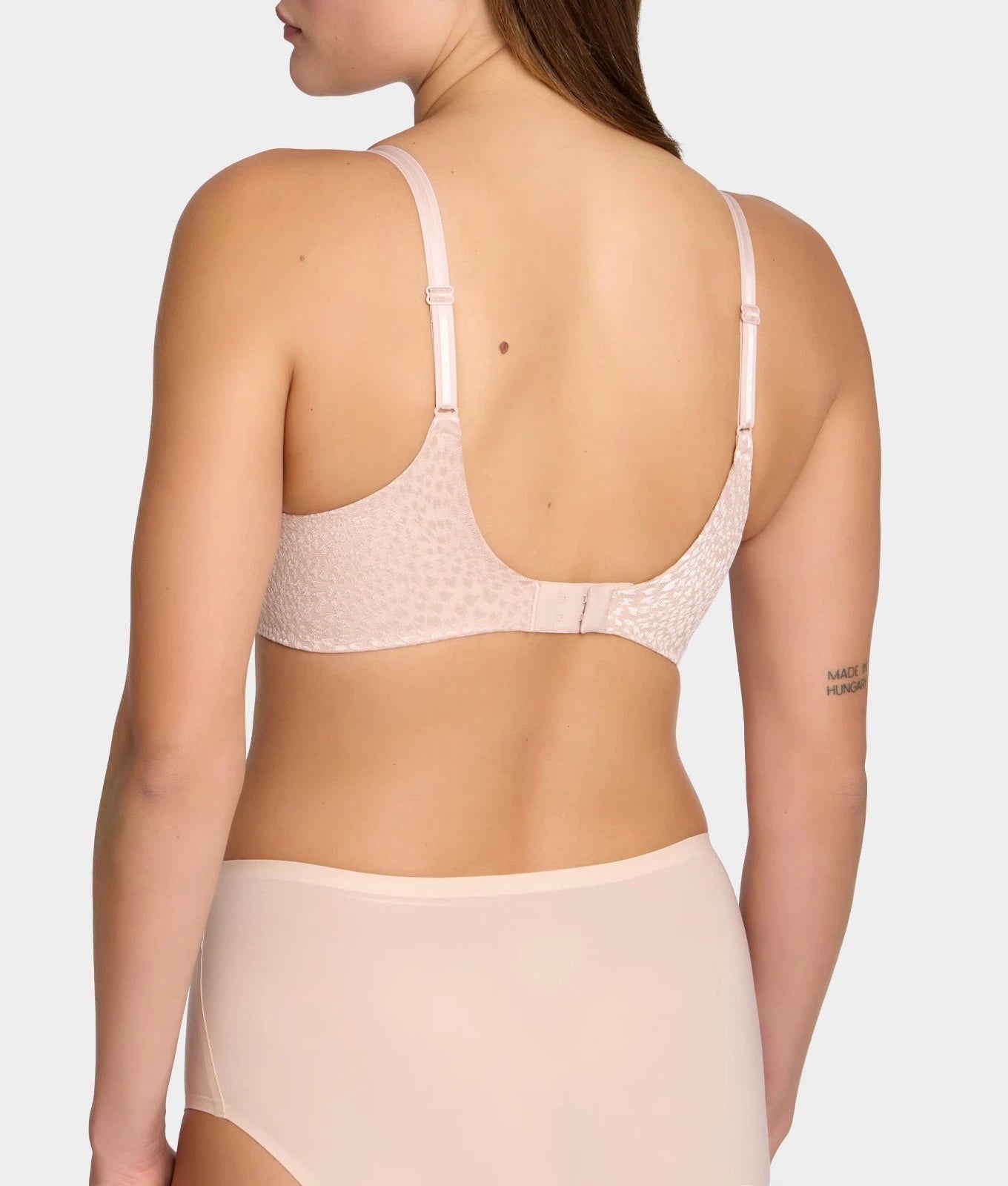 Magique minimizer bra blush pink lace with thin adjustable straps and seamless back design shown from back side
