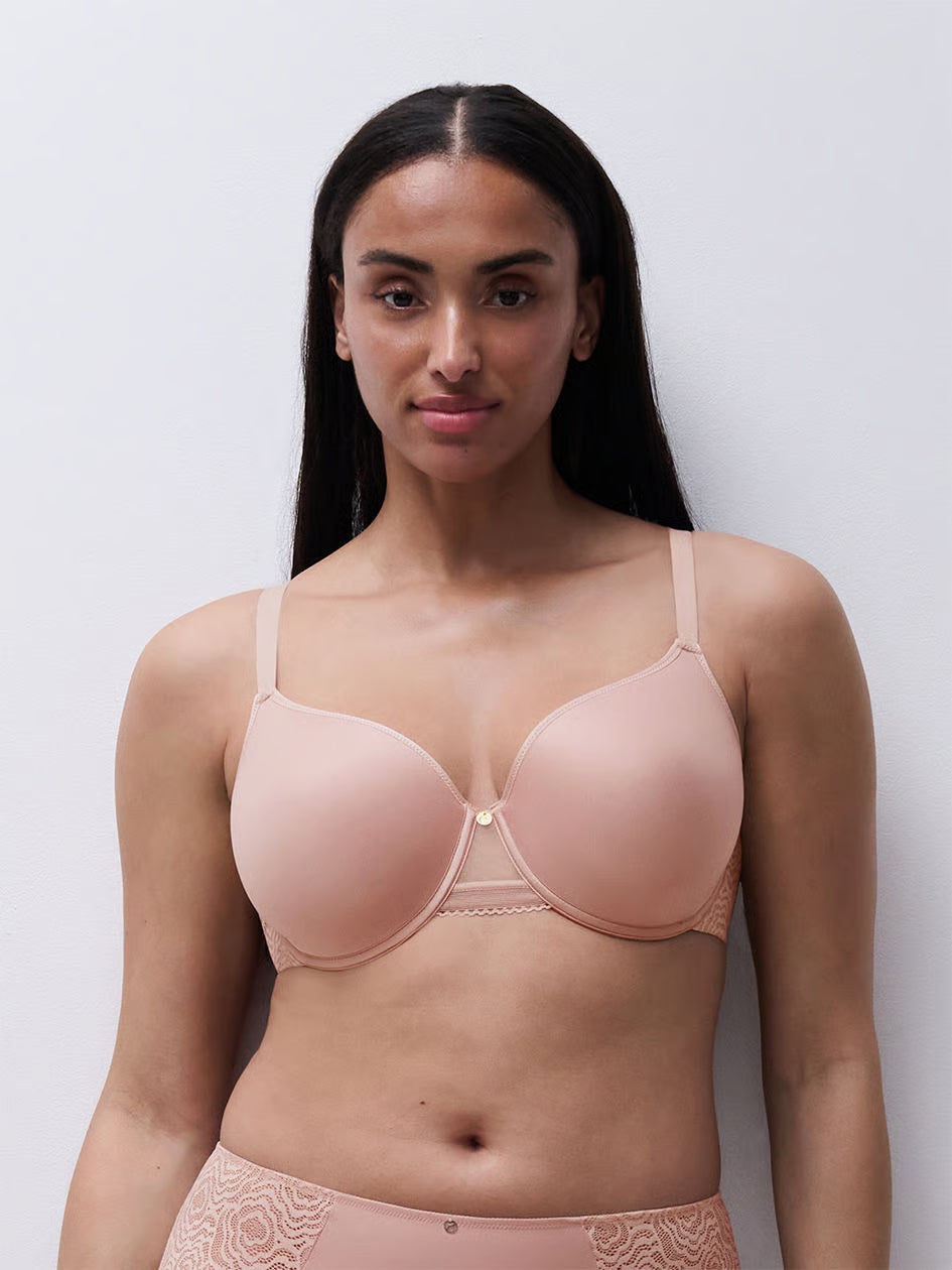 A soft blush-colored c jolie comfort convertible t-shirt bra with underwire and delicate lace trim along the edges