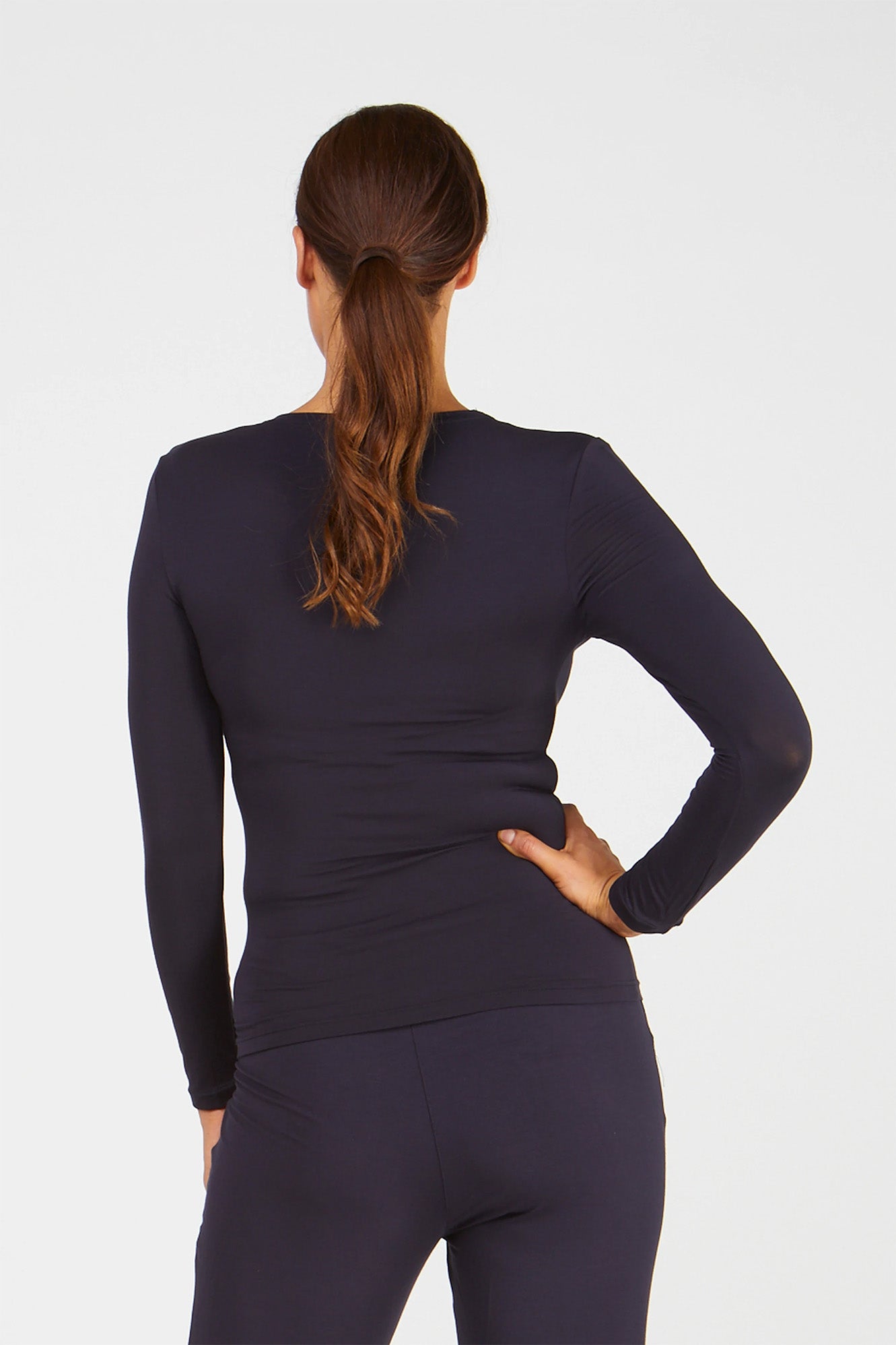 Woman wearing Tani 79276 High Neck Long Sleeve in French Navy back view